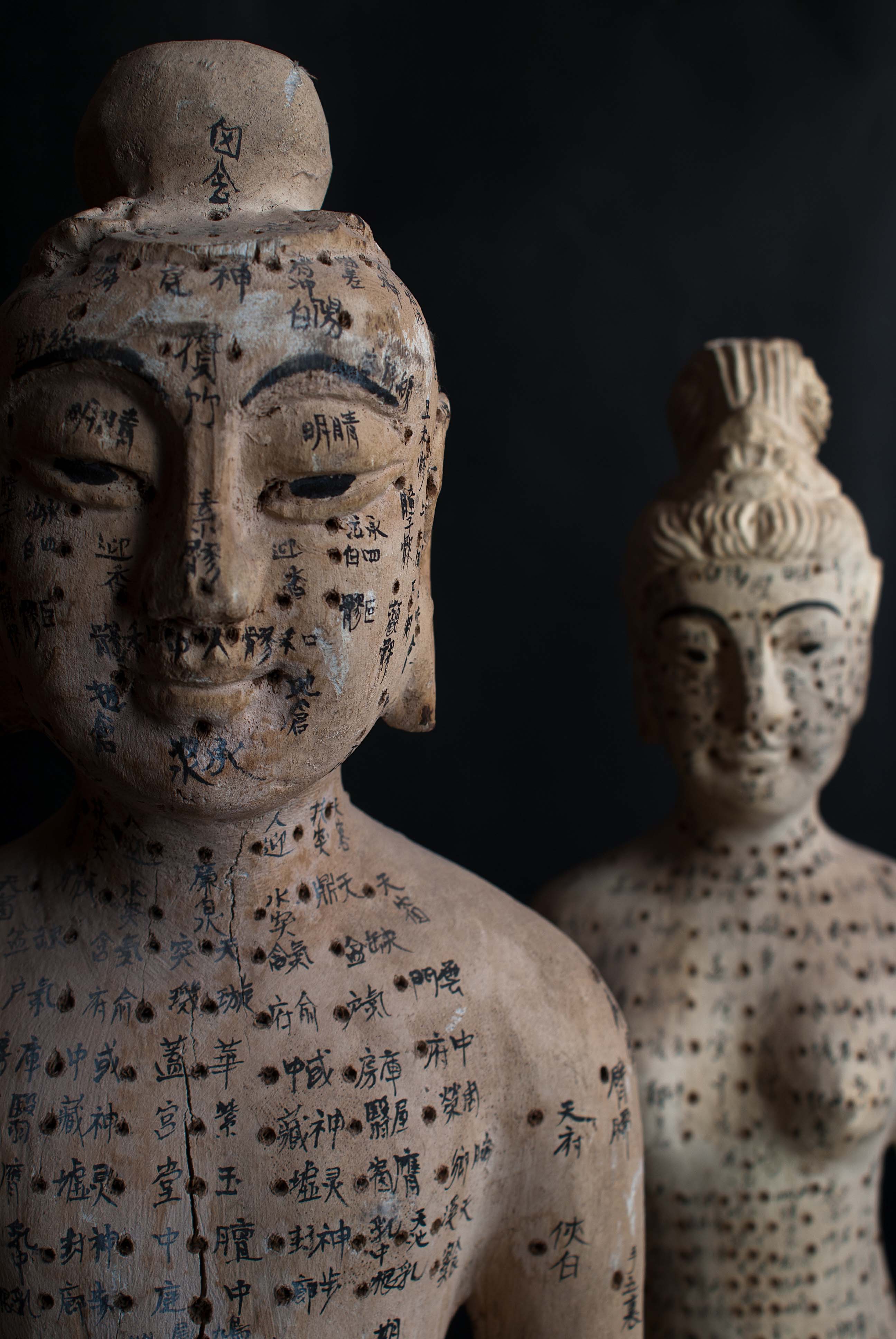 Two ancient Chinese model of human torso with Chinese characters written at the acupuncture point locations